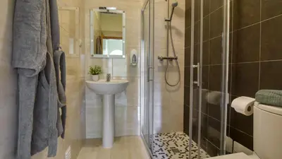 a bathroom with a shower and a sink and a toilet at 8-Bed Villa in Vilamoura-Sleeps-Playground-Pool in Vilamoura