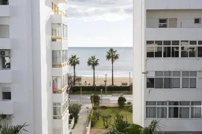 a view of the beach from between two buildings at Terraços de Quarteira Green by Real Properties in Quarteira