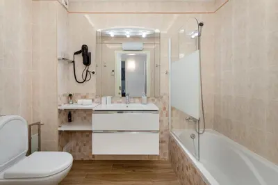 a white bedroom with a bed and a mirror at Centralgarve - Villa Crown 22 in Quarteira