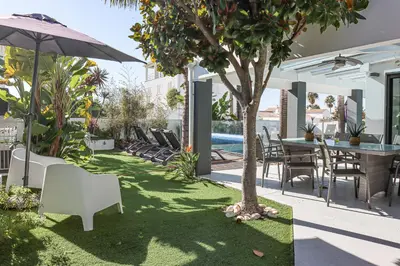 a patio with a table and chairs and a tree at Villa Stefy by Bedzy in Galé