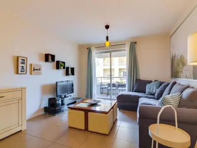 a living room with a couch and a tv at AL - Apartamento Carteia in Quarteira