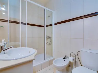 a bathroom with a shower and a toilet and a sink at AL - Apartamento Pinhal da Praia in Vilamoura