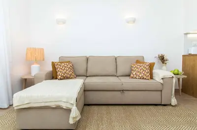 a living room with a couch and a table at Oura 7 in Albufeira