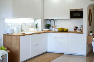 a white kitchen with white cabinets and a sink at Oura 7 in Albufeira