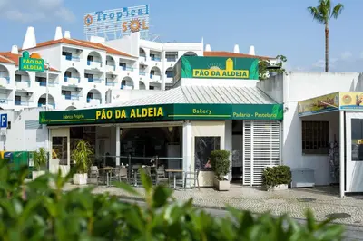 a building with a restaurant in front of it at Oura 7 in Albufeira