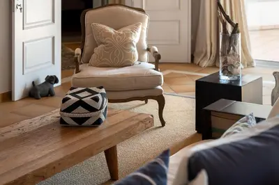 a living room with a chair and a coffee table at Villa Anna - Vale de Lobo in Faro