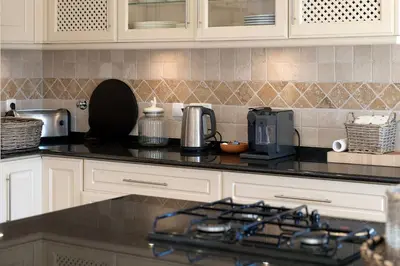 a kitchen with a counter top with a coffee maker at Villa Anna - Vale de Lobo in Faro