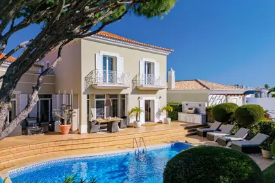 a villa with a swimming pool in front of a house at Villa Anna - Vale de Lobo in Faro