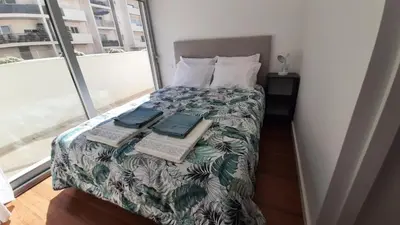 a bedroom with a bed with a computer on it at Panoramic View Apartment in Albufeira