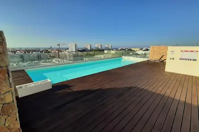 a swimming pool on the roof of a building at Panoramic View Apartment in Albufeira