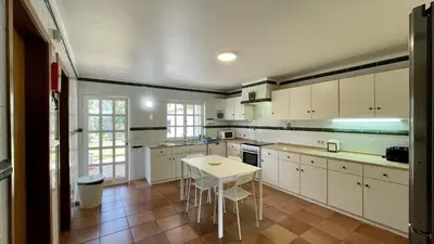 a kitchen with white cabinets and a white table at Espraguina by Check-in Portugal in Loulé