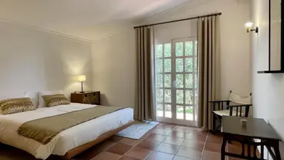 a bedroom with a bed and a large window at Espraguina by Check-in Portugal in Loulé
