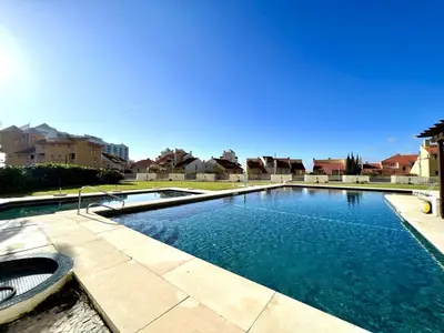 a large swimming pool in a yard with houses at Vilamoura Marina Mar 2 With Pool by Homing in Vilamoura