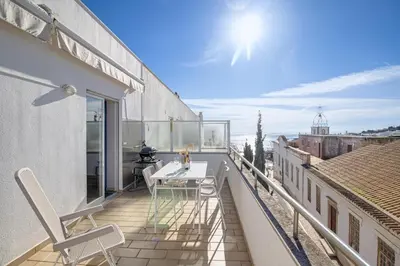 a balcony with a table and chairs on a building at Old Town 2BR 50m Ocean w/ AC Wi-Fi Parking Terrace in Albufeira