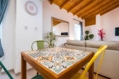 a dining room with a table and a couch at Downtown Lady Terrace in Faro