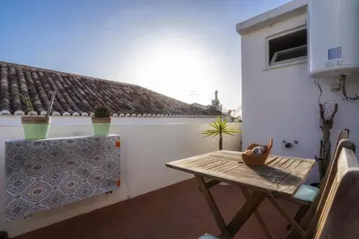 a table and chairs on a balcony with a roof at Downtown Lady Terrace in Faro