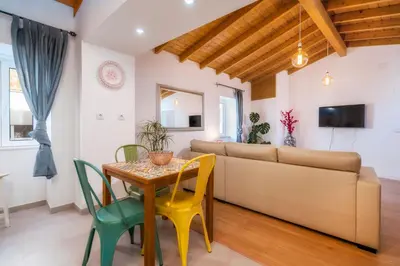 a living room with a table and a couch at Downtown Lady Terrace in Faro
