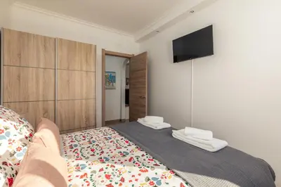 a bedroom with a bed with towels on it at Apartamento Sunset on the Sea in Albufeira