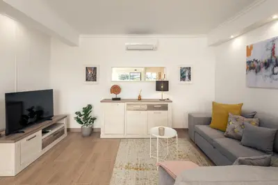 a bedroom with a bed and a flat screen tv at Apartamento Sunset on the Sea in Albufeira