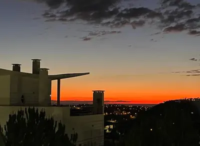 a sunset view of a building and a city at by blen.d in Albufeira