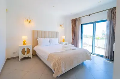 a bedroom with a large bed and a large window at Ocean View Villa in Boliqueime