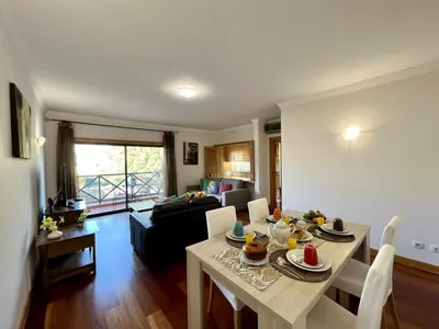 a kitchen and living room with a table with food on it at Albufeira Modern 4 With Pool by Homing in Albufeira