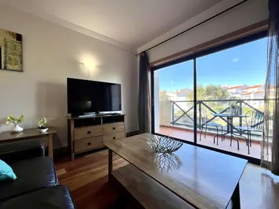 a living room with a tv and a large window at Albufeira Modern 4 With Pool by Homing in Albufeira