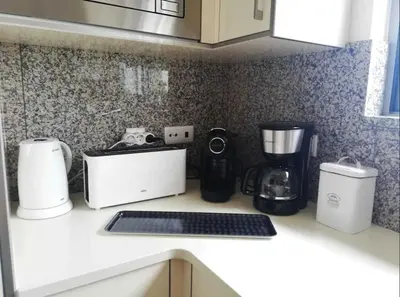 a kitchen counter with various appliances on it at Spacieux Appartement Logis des Fées de la Marina en rez-de-chaussée de chaussée in Albufeira