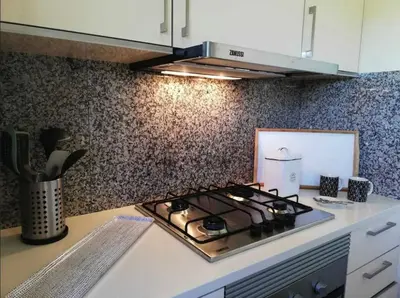 a kitchen with a stove top on a counter at Spacieux Appartement Logis des Fées de la Marina en rez-de-chaussée de chaussée in Albufeira