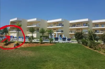 a large apartment building with a red circle around it at Spacieux Appartement Logis des Fées de la Marina en rez-de-chaussée de chaussée in Albufeira