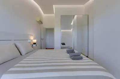 a bedroom with a bed with two blue towels on it at VILASOL - 