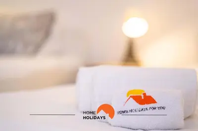 a pile of towels sitting on top of a bed at #112 Oura Flat by Home Holidays in Albufeira