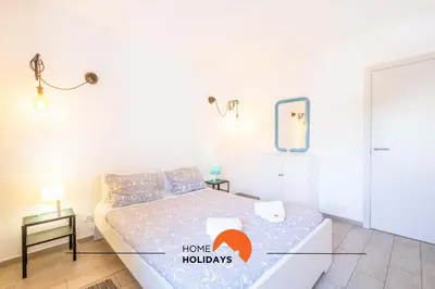 a living room with a blue couch and a tv at #112 Oura Flat by Home Holidays in Albufeira