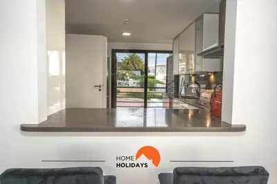 a living room with a view of a house at #111 Ocean View by Home Holidays in Albufeira
