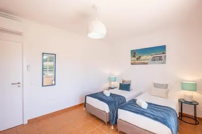 two beds in a room with white walls at Beachsun Gale - beautiful villa close to beach in Galé