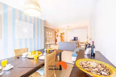 a living room with a table and a dining room at #115 Bernardo Flat by Home Holidays in Albufeira
