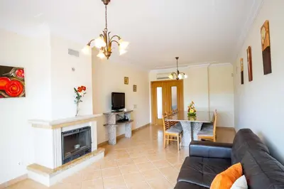 a living room with a couch and a fireplace at Apartment Hugo - Complex perfect for families in Albufeira