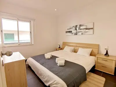 a bedroom with a bed with two towels on it at Vilamoura Neptuno in Quarteira