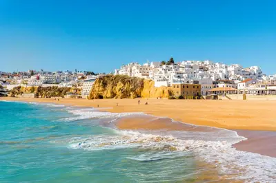 a view of a beach with buildings in the background at Muito Sol in Albufeira