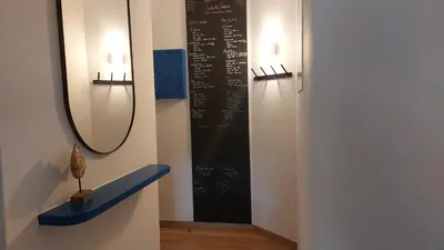 a room with a chalkboard on a wall with a mirror at AZULEJOS em VILAMOURA PORTUGAL in Vilamoura
