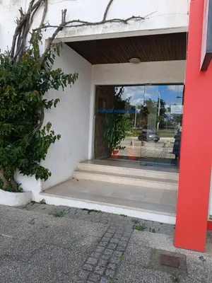 a store front with a red door and a window at AZULEJOS em VILAMOURA PORTUGAL in Vilamoura