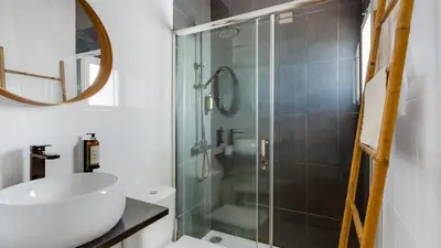 a bathroom with a glass shower and a sink at Terraços do Mar Apartment W/ Pool by LovelyStay in Vilamoura