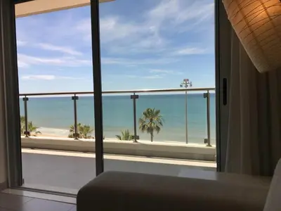a room with a view of the ocean from a balcony at Pure Sea - Beach Apartment in Quarteira