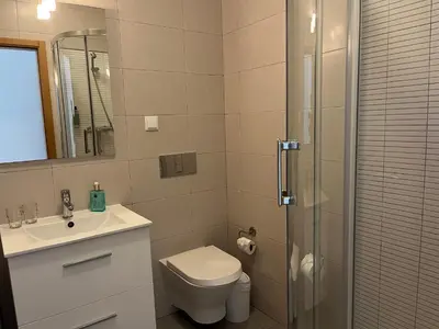 a bathroom with a toilet and a sink and a shower at Pure Sea - Beach Apartment in Quarteira