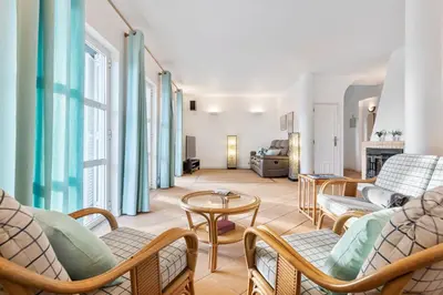 a living room with chairs and a table at Villa Luz do Atlantico by OCvillas in Galé