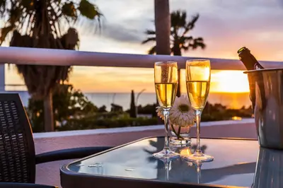 two glasses of champagne on a table with a view of the ocean at Villa Luz do Atlantico by OCvillas in Galé