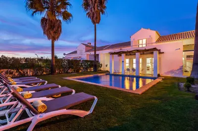 a backyard with lounge chairs and a swimming pool at Villa Luz do Atlantico by OCvillas in Galé