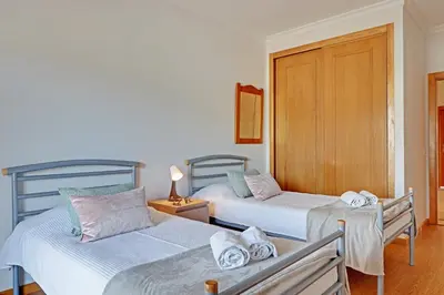 a bedroom with two beds with towels on them at Palm Beach Apartment in Vilamoura