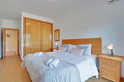 a bedroom with a bed with two towels on it at Palm Beach Apartment in Vilamoura