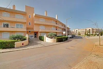 an empty street in front of a apartment building at Palm Beach Apartment in Vilamoura